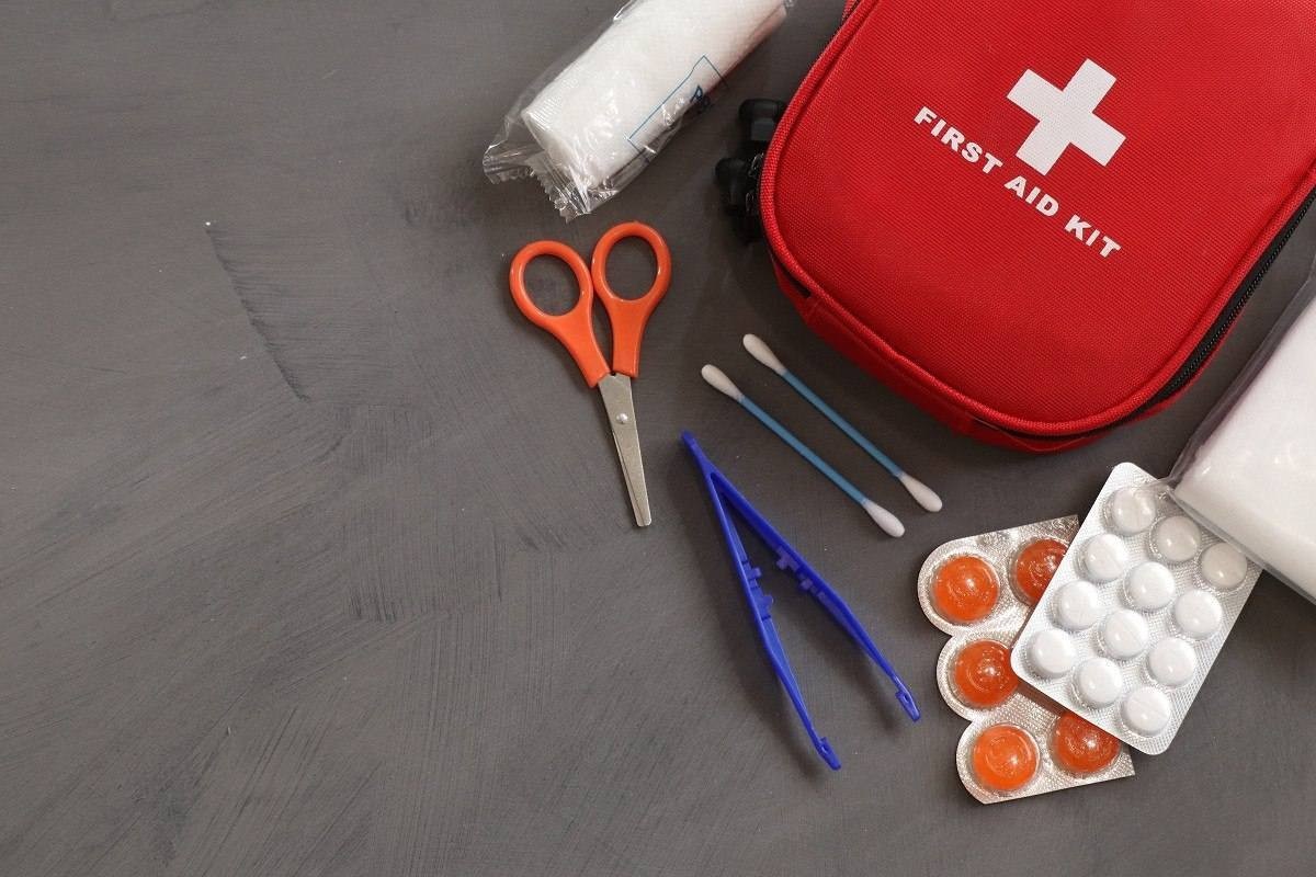 Kit de primeiros socorros contendo tesoura, cotonetes, pinça, remédios, gaze e bolsinha