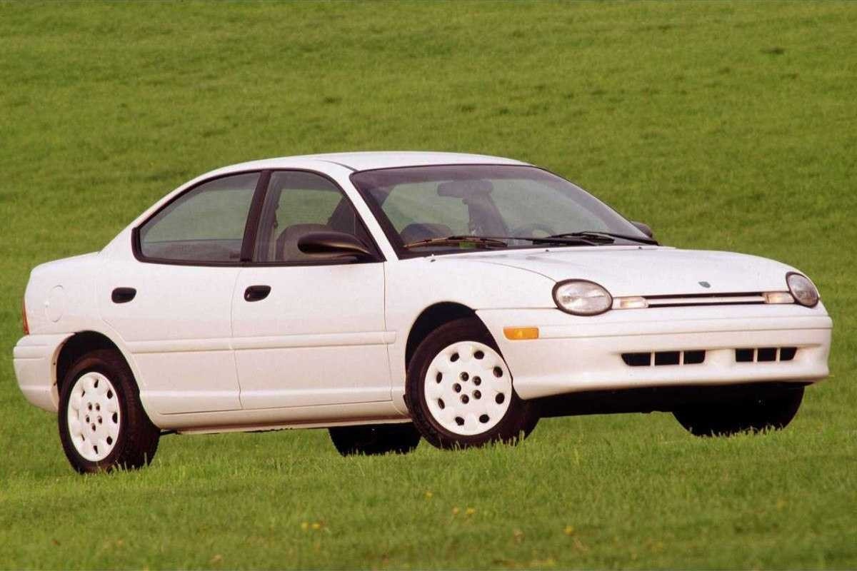 Dodge Neon branco de frente estacionado em gramado