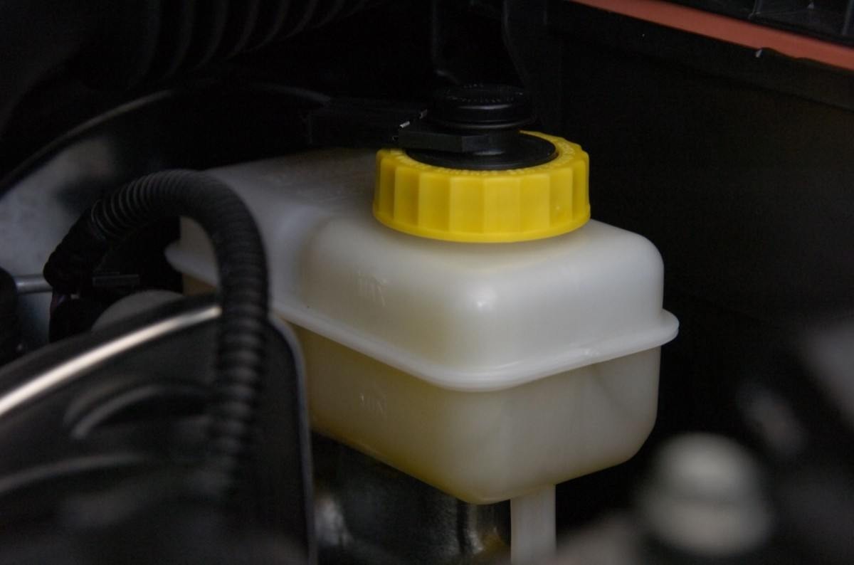 Sistema de freio detalhe do reservatório do fluido de freio amarelo manutenção em oficina mecânica