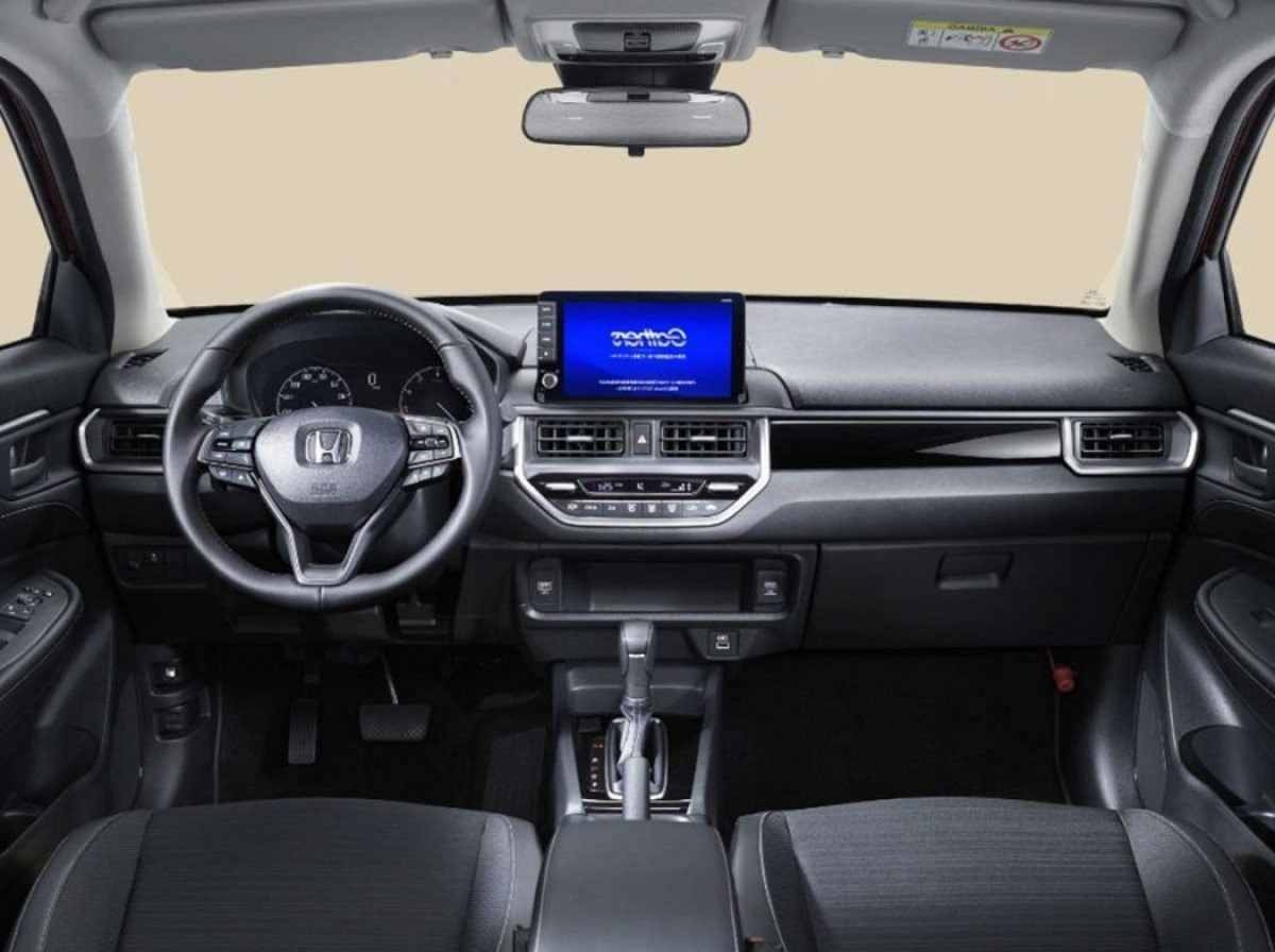 Honda WR-V modelo 2025 SUV compacto vermelho interior painel volante e bancos dianteiros estático no estúdio
